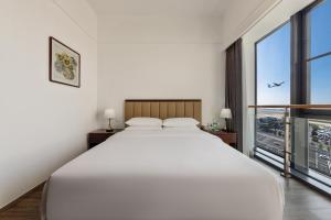 Postel nebo postele na pokoji v ubytování 北京明珠酒店Beijing CSN Pearl Hotel