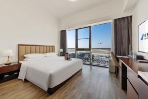 Postel nebo postele na pokoji v ubytování 北京明珠酒店Beijing CSN Pearl Hotel