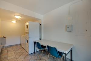 a kitchen with a table and two chairs and a refrigerator at Motel 6-Bellingham, WA in Bellingham