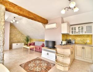 a kitchen and living room in a house at Sirena Palace Family Hotel in Obzor