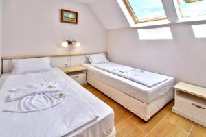 a bedroom with two beds and a window at Sirena Palace Family Hotel in Obzor