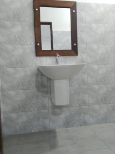 a bathroom with a sink and a mirror at Hirudee Villa in Unawatuna +6 photos