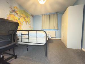 a bedroom with a bed and a map on the wall at Bright Double Room in Wellingborough in Harrowden