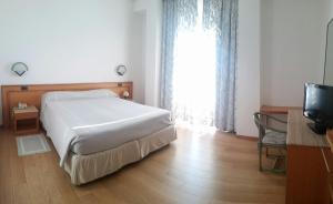 Postel nebo postele na pokoji v ubytování Hotel Excelsior