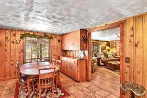 a kitchen and dining room with a table and chairs at Rare Log Cabin Treasure Close to Grand Canyon Now with Wi-Fi in Parks +40 photos