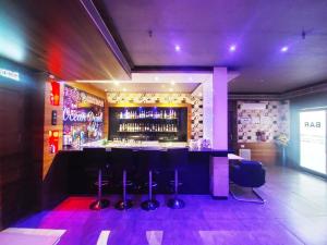 een bar met paarse verlichting in een restaurant bij Hotel Brahmani in Jajpur Road