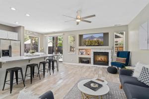 a kitchen and living room with a fireplace at Sublime Mountain Retreat Pool Table Fire-Pit Arcade Game Ideal Location w Central AC in Flagstaff