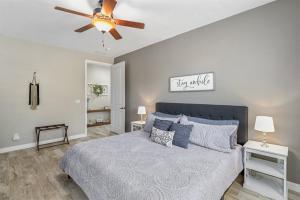 a bedroom with a bed with a ceiling fan at Sublime Mountain Retreat Pool Table Fire-Pit Arcade Game Ideal Location w Central AC in Flagstaff