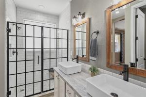 a bathroom with two sinks and a large mirror at Sublime Mountain Retreat Pool Table Fire-Pit Arcade Game Ideal Location w Central AC in Flagstaff +32 photos