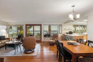 a kitchen and living room with a table and chairs at 3 Bed Gorgeous Views Hot Tub Dog Friendly Ada in Langley