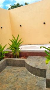a white bath tub sitting next to a building at Eden Garden Bandipur Tiger Reserve in Gundlupet +6 photos