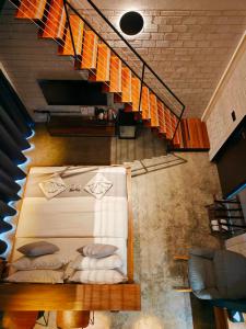 a room with a bed with pillows and a staircase at M5 Hotel in Chiang Mai