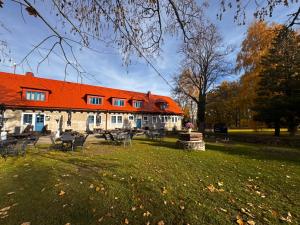 a building with an orange roof in a park at Penzion Landštejnský dvůr in Slavonice