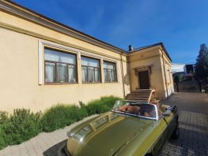 a green car parked in front of a house at Central House Craiova in Craiova