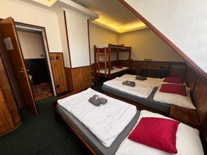 a room with two beds and a staircase at Penzion Landštejnský dvůr in Slavonice