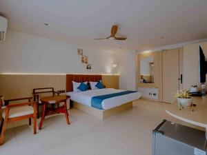 a bedroom with a bed and a table and a room at Nine, Boutique hotel with luxury room stay, mysore in Mysore