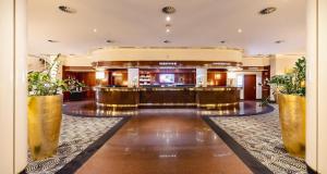 a lobby of a hotel with a bar at PLAZA Premium Darmstadt in Darmstadt
