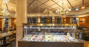 a display case in a restaurant with a lot of food at PLAZA Premium Darmstadt in Darmstadt