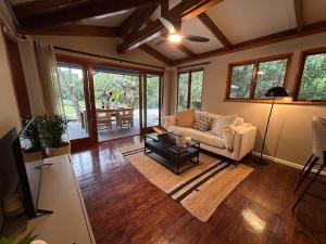 a living room with a couch and a table at The Cabin Luxury Safari Villa in Somerset