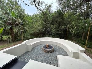 a courtyard with a fire pit in the middle at The Cabin Luxury Safari Villa in Somerset