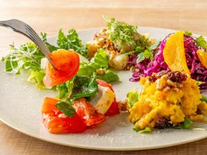 a plate of food with a salad on a table at Tokyu Stay Hakata in Fukuoka +204 photos