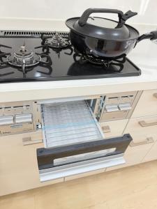 a pot on a stove top in a kitchen at PUZZLE hotel 301 in Tokyo