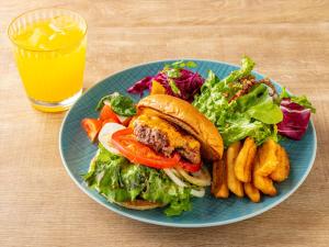 a blue plate with a sandwich and a salad and fries at Tokyu Stay Hakata in Fukuoka