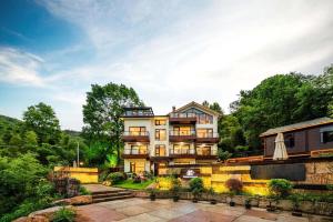 a house on a hill with a garden at Shenshan Wild Escape （Lure Fishing and More） in Qingshan