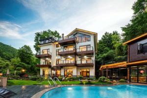 an exterior view of a house with a swimming pool at Shenshan Wild Escape （Lure Fishing and More） in Qingshan