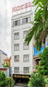 a large white hotel with a sign in front of it at Grand Vĩnh Tuy Hanoi Hotel&Spa in Mai Phúc