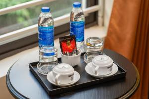 a tray with two bottles and glasses on a table at Grand Vĩnh Tuy Hanoi Hotel&Spa in Mai Phúc +15 photos