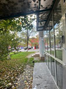 an outside view of a building with leaves on the ground at Cozy Apartment Hunedoara in Hunedoara