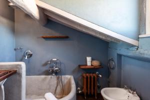 a bathroom with a bath tub and a sink at Il Mazzocchio - Lucca Centro in Lucca +15 photos