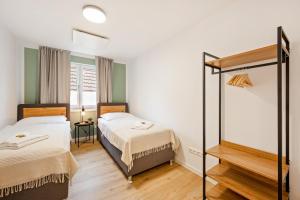 a bedroom with two beds and a mirror at CharmÖHR Homes in Öhringen