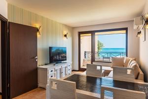 金沙Beach Front Suites SEAVIEW BG的配有电视、桌椅的客厅