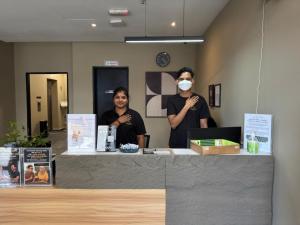 two people standing behind a counter wearing a mask at Swing & Pillows - CIQ Johor Bahru in Johor Bahru