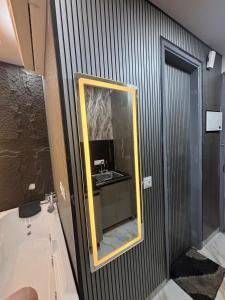 a bathroom with a mirror and a sink at Suite with Private Jacuzzi in Ghaziabad