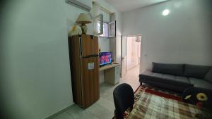 a living room with a couch and a tv at Taku house in Durrës