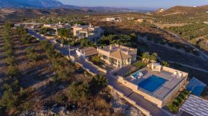 an aerial view of a house with a swimming pool at Koronio Villas in Kalamaki