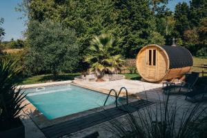 a small swimming pool next to a hobbit house at Gite et chambres d'Hotes de Cozance in Anjou