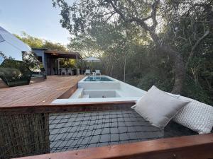 a bath tub sitting on a wooden deck at The Dome Luxury Safari Villa in Hluhluwe
