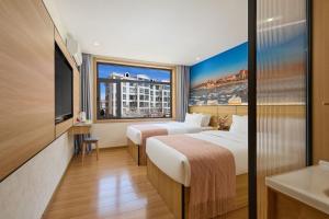 a hotel room with two beds and a large window at Floral Hotel Beidaihe Migao Intelligent Hotel in Qinhuangdao
