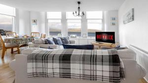 a living room with a couch and a table at The Hidden Asset- Rothesay, Isle of Bute in Rothesay