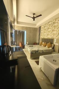 a bedroom with a bed and a bathroom with a sink at Suite with Private Jacuzzi in Ghaziabad