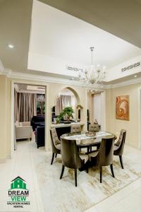 a dining room with a table and chairs at Souk Al Bahar View Burj Khalifa and Fountains Dream View Holiday Homes in Dubai