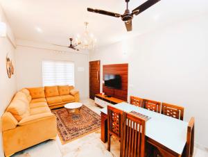 a living room with a couch and a table at 88 HOMES Near LULU MALL EDAPALLY in Cochin