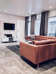 ein Wohnzimmer mit Couch und Flachbildfernseher in der Unterkunft Villa Pinja in Kalajoki + 11 Fotos