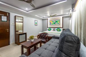 a living room with a couch and a bed at Treebo Marina Grand, Railway station in Visakhapatnam +30 photos
