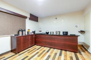 a kitchen with a counter in a room at Treebo Marina Grand, Railway station in Visakhapatnam