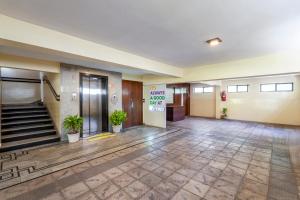 an empty lobby of a building with stairs and plants at Treebo Marina Grand, Railway station in Visakhapatnam